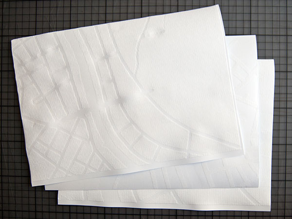 Three embossed A4 sized paper sheets showing a map.