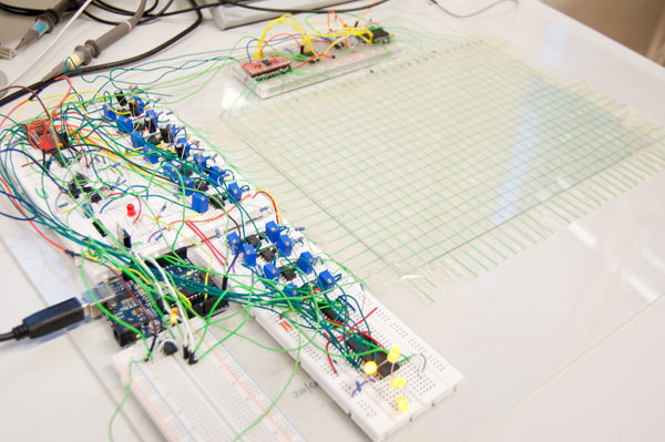 An A4 sized wire grid, with ca. 700 crosspoints. Connected are several breadboards and an Arduino board.